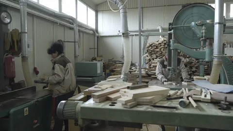 Woodworker using band saw and female joiner working on sander machine in factory 動画素材 88058714