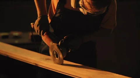 Woodworker using grinding tool for polishing plank. Craftman working in Stock Footage 114695216