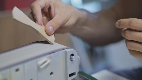 Woodworker using a power tool to achieve soft and smooth edges on the Stock Footage 95289068
