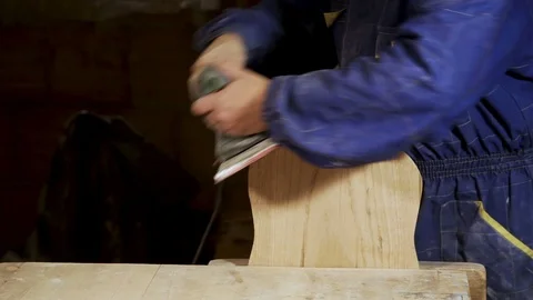 Woodworker works with electric Sander in workshop. Stock Footage 100771796