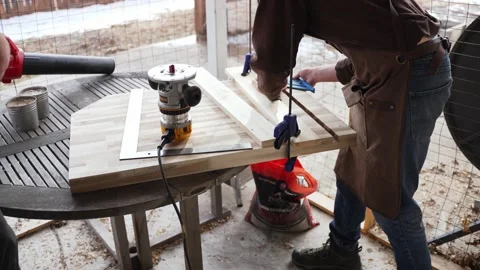 Woodworkers using a leaf blower to clear Sawdust from their workstation. Stock Footage 231955498