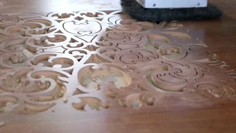 Woodworking CNC router machine cuts a pattern on a piece of wood. Stock Footage 186936283