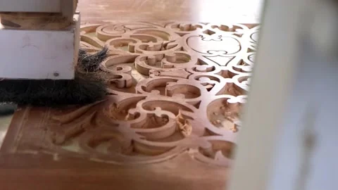 Woodworking CNC router machine cuts a pattern on a piece of wood. Stock Footage 186936360