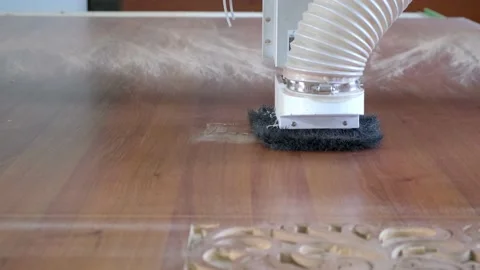 Woodworking CNC router machine cuts a pattern on a piece of wood. Stock Footage 186936386