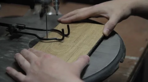 Woodworking cutting a board with a scroll saw Stock Footage 42235633