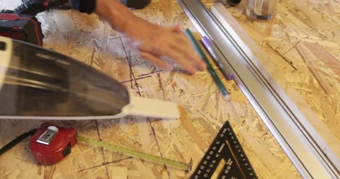 Woodworking diy, dusting saw dust from OSB panel plate, close up Stock Footage 329427306