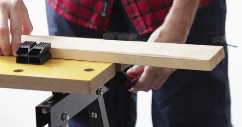 Woodworking, fixing lumber plank into workbench clamps Stock Footage 153283078