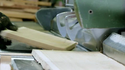 Woodworking industry. With the help of a large sharp saw, the board is cut Stock Footage 200772586