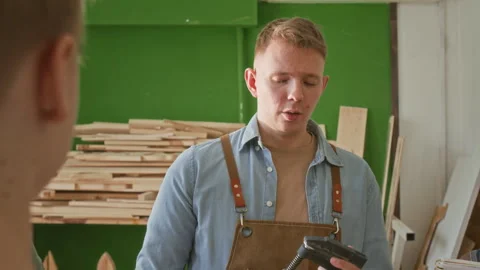 Woodworking Instructor Answering Question of Boy Raising Hand during Explanation Stock Footage 334426499