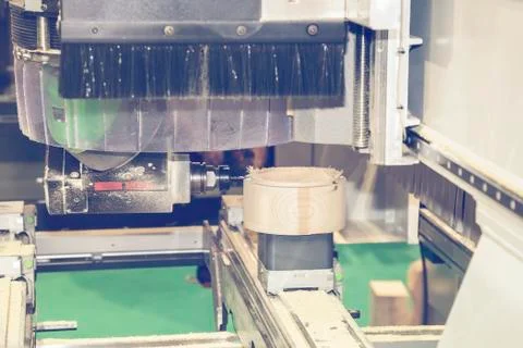 Woodworking machine with drill during processing Stock Photos