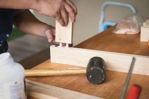 Woodworking operators are using glue to put together the wood parts to assemble Stock Photos