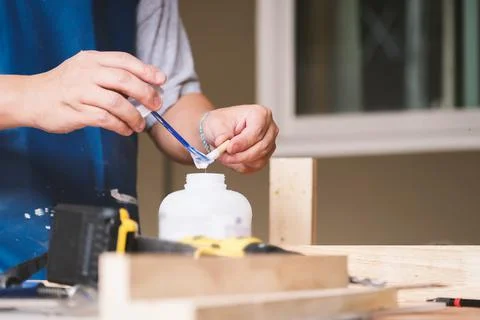 Woodworking operators are using glue to put together the wood parts to assemble Stock Photos