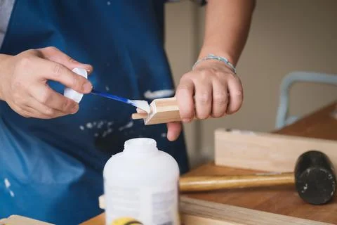Woodworking operators are using glue to put together the wood parts to assemble Stock Photos