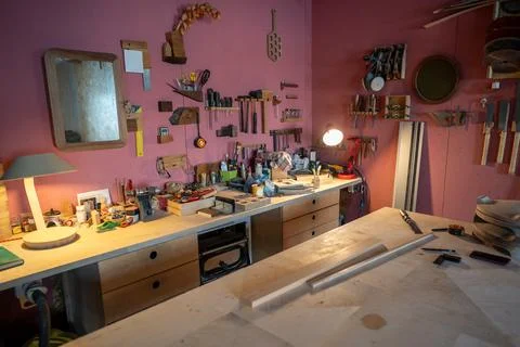 Woodworking studio with organized power tools and clean work surface at day Stock Photos