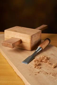 Woodworking tool. Mallet with chisel and savings on workbench. Stock Photos