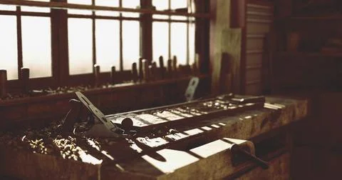 Woodworking tools on a workbench in a rustic workshop during daylight hours Stock Illustration