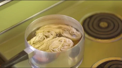 Wool being boiled on pot in kitchen at home Video stock 76097978