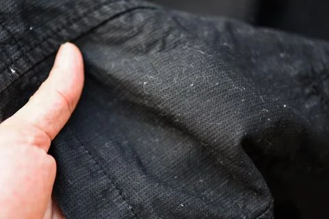 Wool on clothes removing spools from a fabric concept, Problem of poor clothi Stock Photos