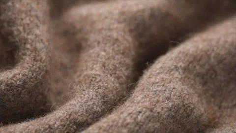 Wool knitted background. Real natural beige color wool mohair clothes texture Stock Footage 330538584