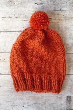 Wool orange pompom hat Stock Photos