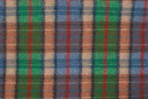 Wool plaid texture. Soft and warm folded alpaca wool blanket. Green and ora.. Stock Photos