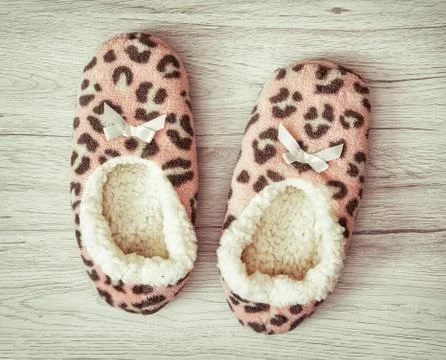 Wool slippers on the wooden background, retro style Stock Photos