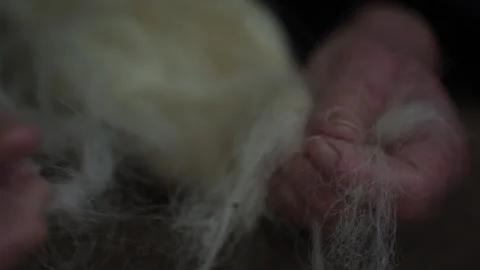 Wool Spinning by Elderly Hands Showcasing Primitive Textile Crafting Techniques Stock Footage 297972863