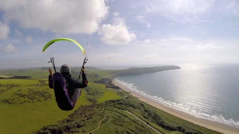 Woolacombe, Devon, United Kingdom - 2016: Paraglider flying along coastline 스톡 동영상 169665503