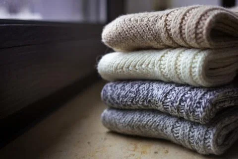 Woolen clothes on a home background. Stock Photos