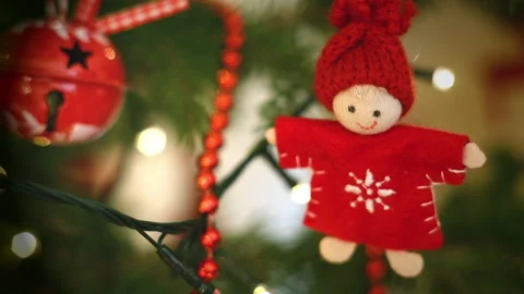 Woolen handmade doll with red knit hat swinging on Christmas tree Stock Footage 145281679