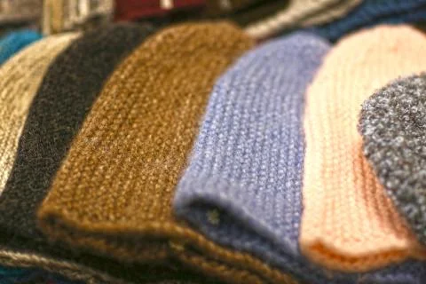 Woolen hat assortment on market showcase Stock Photos