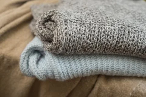 Woolen pullover stacked at home Stock Photos