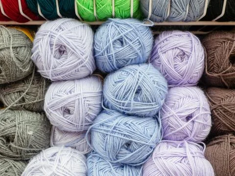 Woolen skeins of thread for knitting are arranged according to colors Stock Photos