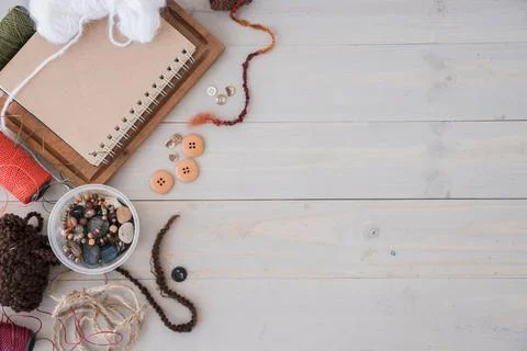 Wools beads string spool wooden desk Stock Photos
