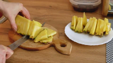 Woomen slices the pineapple Stock Footage 147442171