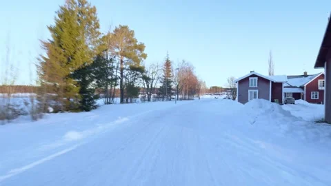 Wooshing through a snowy landscape and small city in a winter wonderland Stock Footage 169084910