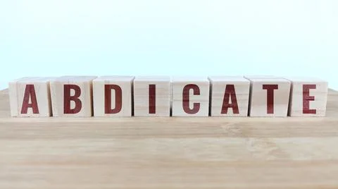 Word abdicate written with wood cubes on table Stock Photos