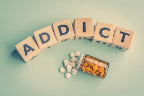 The word addict on a table Stock Photos