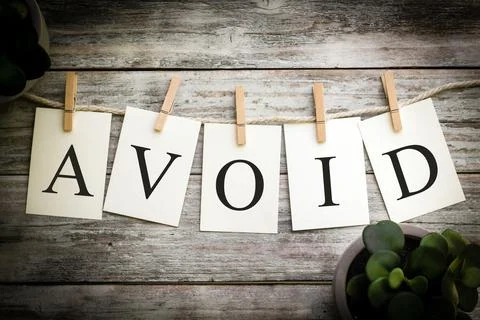 The Word AVOID Concept Printed on Cards Stock Photos