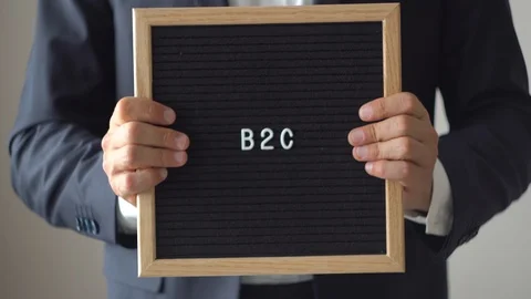 Word B2C from Letters on Text Board in Anonymous Businessman Hands Stock-Footage 97611460