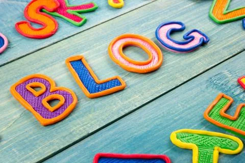 Word BLOG made with plasticine letters on old wooden blue board background Stock Photos
