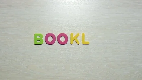 Word booklet is made up of plastic colored letters Stock Footage 79848577