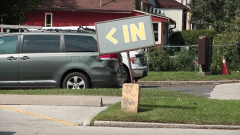 In word caption text writing sign in yellow on gray background on post on grass Stock Footage 252043764