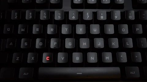 The word cheating is typed on a luminous computer keyboard. Black backlit Stock Footage 118276177