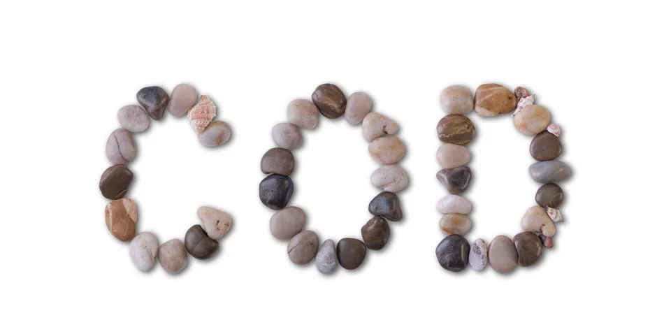 The word "COD" is lined with shells and stones of different shapes and colors Фото