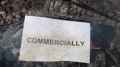 Word Commercially on a white sheet of paper burns into a fire against. Stock Footage 141723397