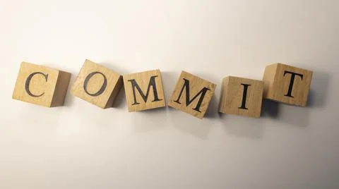 The word Commit was created from wooden cubes.Close-up. Foto stock