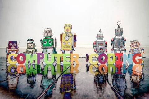 The word  COMPUTER CODING with vintage robot toys solarized c Foto stock