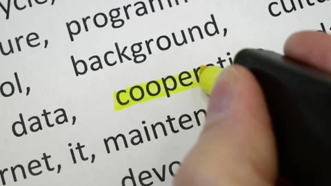 Word cooperation highlighted underlined with a colored marker on the text. .. Stock Footage 246969665