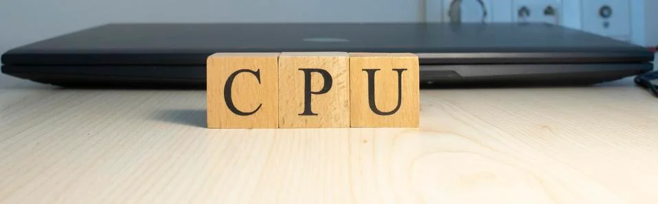 The word CPU is written. Computer and headset in the background. Closeup. Foto stock